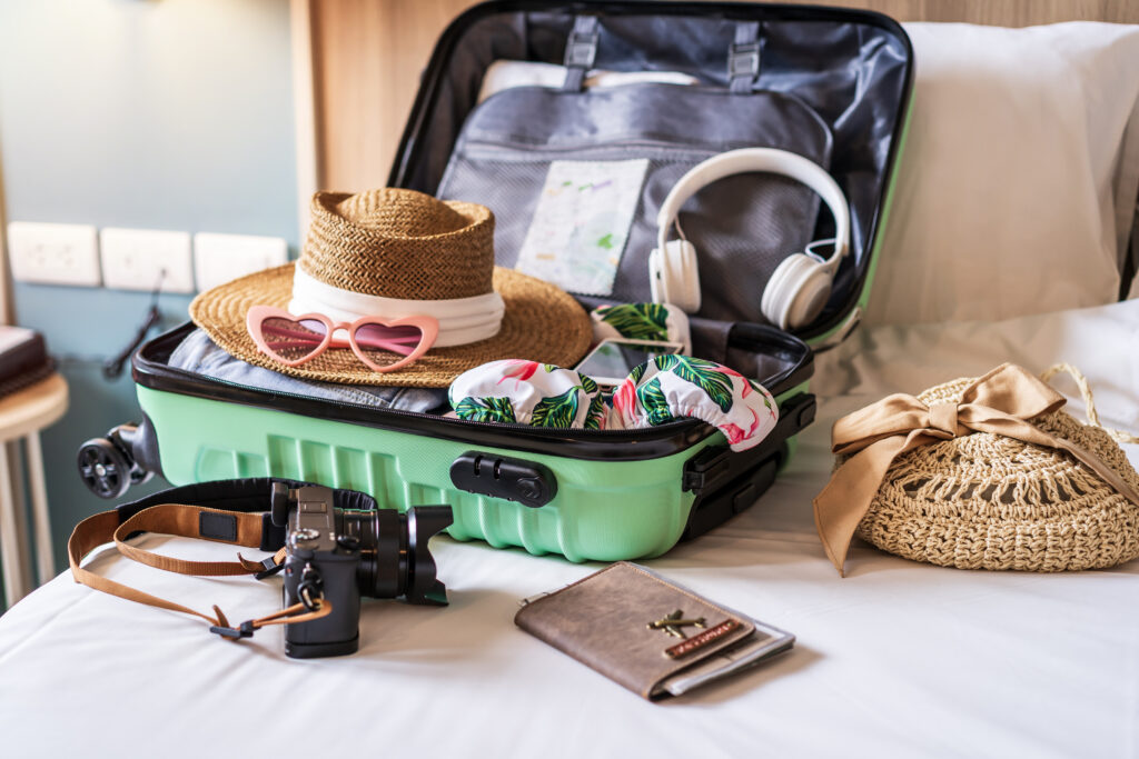 Traveler suitcase and luggage with travel accessories and items preparing for travel